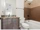 Cozy bathroom featuring granite countertop vanity, bath, and shower combo with bronze fixtures and brown accent tile at 17129 Breeders Cup Dr, Odessa, FL 33556