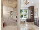 Luxurious bathroom featuring a walk-in shower, soaking tub, and travertine floors at 17129 Breeders Cup Dr, Odessa, FL 33556