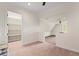 Bright bonus room featuring neutral tones, a large window, and a walk-in closet at 17129 Breeders Cup Dr, Odessa, FL 33556