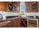 Charming butler's pantry with wine storage, granite countertops, and custom cabinetry at 17129 Breeders Cup Dr, Odessa, FL 33556
