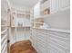 Spacious walk-in closet with custom shelving and storage at 17129 Breeders Cup Dr, Odessa, FL 33556