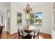 Cozy dining area with a round table, four chairs, and views of the landscaped backyard at 17129 Breeders Cup Dr, Odessa, FL 33556