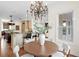 Dining area featuring modern chandelier, wood table and views to open kitchen at 17129 Breeders Cup Dr, Odessa, FL 33556