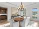 Bright dining room featuring a wooden table and a large, decorative chandelier at 17129 Breeders Cup Dr, Odessa, FL 33556