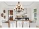 Elegant dining room with tray ceilings, stylish chandelier, and wainscoting at 17129 Breeders Cup Dr, Odessa, FL 33556