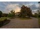 Circular paver driveway adorned with beautiful trees and landscaping leading to the elegant home at 17129 Breeders Cup Dr, Odessa, FL 33556
