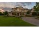 Stately home with a sprawling lawn, manicured landscaping, and a circular driveway for a grand entrance at 17129 Breeders Cup Dr, Odessa, FL 33556