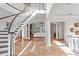 Bright, open foyer with a grand staircase, marble floors, and elegant columns leading to the living areas at 17129 Breeders Cup Dr, Odessa, FL 33556