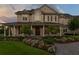 Charming two-story home with a column-lined porch, beautiful landscaping, and a welcoming entrance at 17129 Breeders Cup Dr, Odessa, FL 33556
