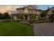 Beautiful two-story home showcasing meticulous landscaping, circular driveway and welcoming column lined porch at 17129 Breeders Cup Dr, Odessa, FL 33556