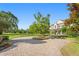 Traditional home with circular driveway, manicured lawn, and mature trees at 17129 Breeders Cup Dr, Odessa, FL 33556