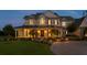 Two-story home with inviting column lined porch, beautiful landscaping, and a welcoming entrance at 17129 Breeders Cup Dr, Odessa, FL 33556