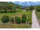Expansive front lawn and circular driveway leading to an elegant home with manicured landscaping at 17129 Breeders Cup Dr, Odessa, FL 33556