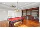 Well-appointed game room featuring a pool table and a wet bar with a mini-fridge at 17129 Breeders Cup Dr, Odessa, FL 33556