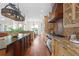 Spacious kitchen featuring a large island, custom cabinets, and stainless steel appliances at 17129 Breeders Cup Dr, Odessa, FL 33556