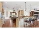 Open-concept kitchen featuring an island, breakfast bar, and modern lighting at 17129 Breeders Cup Dr, Odessa, FL 33556