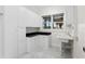Bright laundry room with white cabinets, dark countertops, and a sink at 17129 Breeders Cup Dr, Odessa, FL 33556