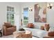 Beautiful living room with comfortable seating, large windows and stylish decor at 17129 Breeders Cup Dr, Odessa, FL 33556