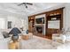 Elegant living room with fireplace, built in wooden shelves, and comfortable seating at 17129 Breeders Cup Dr, Odessa, FL 33556