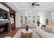 Inviting living room with a coffered ceiling, fireplace, and picturesque backyard views at 17129 Breeders Cup Dr, Odessa, FL 33556