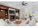 Bright living room with fireplace, custom built-ins, coffered ceilings, and lots of natural light at 17129 Breeders Cup Dr, Odessa, FL 33556
