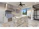 Inviting outdoor kitchen with stone island and stainless steel appliances at 17129 Breeders Cup Dr, Odessa, FL 33556