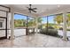 Screened outdoor living area with a stone fireplace and scenic views of the lush backyard at 17129 Breeders Cup Dr, Odessa, FL 33556