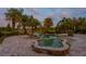 Serene lagoon style pool surrounded by palm trees and lush greenery; ideal for outdoor relaxation at 17129 Breeders Cup Dr, Odessa, FL 33556