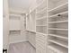 Bright walk-in closet with custom built-in shelving, drawers, and ample storage space for organized living at 17129 Breeders Cup Dr, Odessa, FL 33556