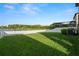 The backyard offers a lake view, green lawn and privacy fence at 1726 Hadden Hall Pl, Trinity, FL 34655