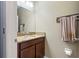 Powder room featuring a granite countertop vanity, mirror, and decorative towel rack at 1726 Hadden Hall Pl, Trinity, FL 34655