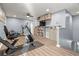 Bonus room features an exercise bike, elliptical, ceiling fan, and built-in shelving at 1726 Hadden Hall Pl, Trinity, FL 34655