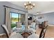 An open-concept dining area features a modern chandelier and backyard views at 1726 Hadden Hall Pl, Trinity, FL 34655