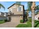 Charming two-story home features a well-manicured lawn, brick driveway, and attached two-car garage at 1726 Hadden Hall Pl, Trinity, FL 34655
