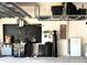 Organized garage with storage racks and wall-mounted tool organizers for efficient space utilization at 1726 Hadden Hall Pl, Trinity, FL 34655
