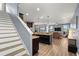 A kitchen flows seamlessly into living room with granite counters, dark cabinets, stainless appliances and pendant lighting at 1726 Hadden Hall Pl, Trinity, FL 34655
