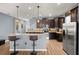 The kitchen features granite countertops, dark wood cabinetry, stainless steel appliances, and wood-look flooring at 1726 Hadden Hall Pl, Trinity, FL 34655