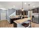 The kitchen features granite countertops, dark wood cabinetry, stainless steel appliances, and wood-look flooring at 1726 Hadden Hall Pl, Trinity, FL 34655