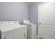 Clean laundry room with modern white washer and dryer units and tiled floors at 1726 Hadden Hall Pl, Trinity, FL 34655