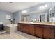 Large ensuite bath with double vanity, soaking tub, and tile flooring at 1726 Hadden Hall Pl, Trinity, FL 34655