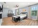 Spacious main bedroom features a ceiling fan, wood-look flooring, and ensuite bath at 1726 Hadden Hall Pl, Trinity, FL 34655
