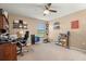 Cozy office featuring a carpeted floor, ceiling fan, and desk with a rolling chair at 1726 Hadden Hall Pl, Trinity, FL 34655