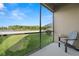 Screened patio with beautiful outdoor views of lush lawn, lake, and landscaping at 1726 Hadden Hall Pl, Trinity, FL 34655