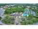 An aerial view of the community clubhouse, pool, tennis courts, landscaping, and surrounding neighborhood at 18107 Sugar Brooke Dr, Tampa, FL 33647