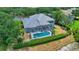 A view of the home from above showcases a private pool with a screened-in patio at 18107 Sugar Brooke Dr, Tampa, FL 33647