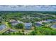 Overhead aerial view showcases neighborhood, several ponds, and a screened-in pool at 18107 Sugar Brooke Dr, Tampa, FL 33647