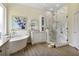 Bright bathroom featuring soaking tub, separate glass shower and white vanity and fixtures at 18107 Sugar Brooke Dr, Tampa, FL 33647