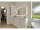 Bright bathroom with modern vanity, backlit mirror and access to the walk-in closet at 18107 Sugar Brooke Dr, Tampa, FL 33647