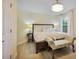 Bright bedroom with a beautiful chandelier, neutral walls, and light wood floors at 18107 Sugar Brooke Dr, Tampa, FL 33647