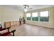 Spacious bonus room featuring natural light, wood floors, and a decorative ceiling fan at 18107 Sugar Brooke Dr, Tampa, FL 33647
